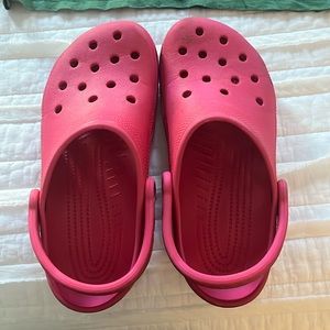 Crocs. Some scuffs on front and back. No rips or tears